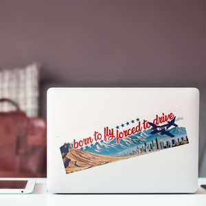 Born_to_fly_forced_to_drive_bumper_stick_ClearBumperSticker_Laptop_Mockup.png_15837405
